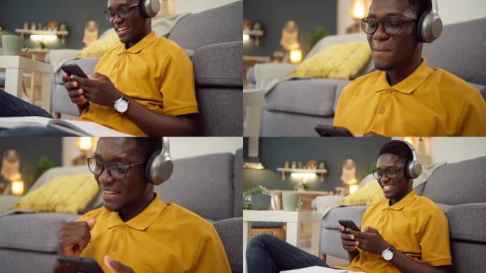 非洲裔美国人一边用手机一边用无线耳机听音乐