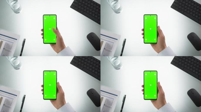 匿名人士使用智能手机模拟绿屏Chromakey显示与运动跟踪占位符。经理在线浏览，在手机上滑动和轻敲