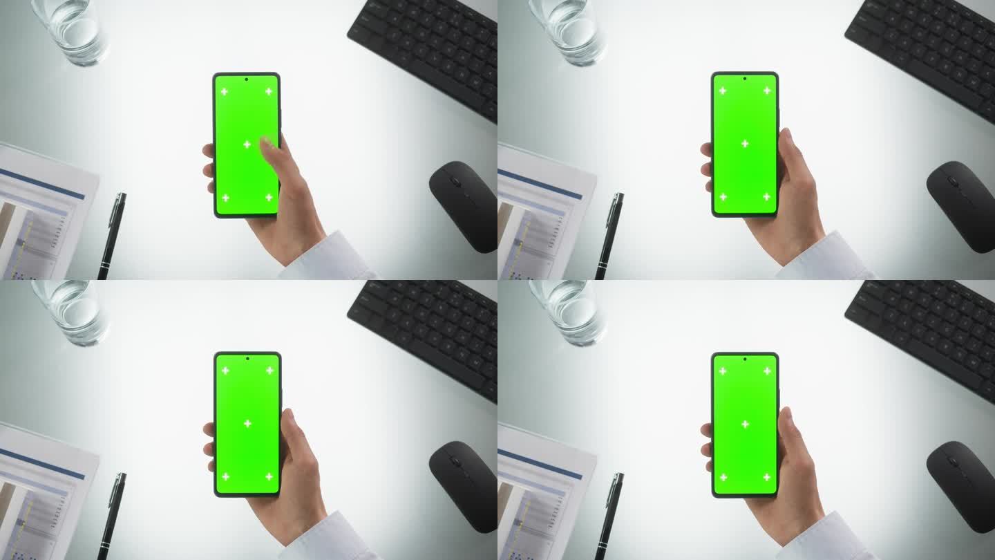 匿名人士使用智能手机模拟绿屏Chromakey显示与运动跟踪占位符。经理在线浏览，在手机上滑动和轻敲