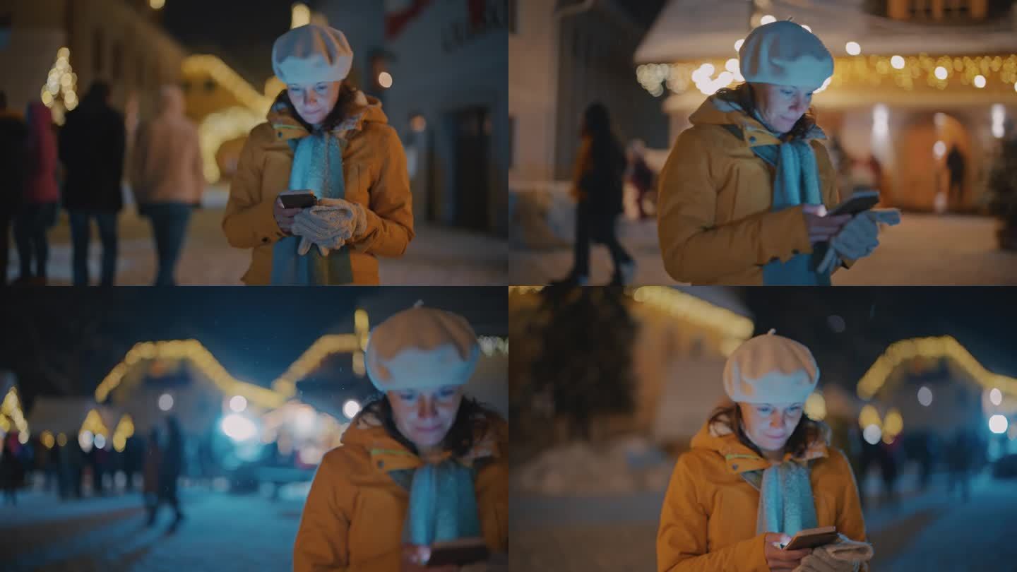 一名妇女走过圣诞市场时正在使用手机