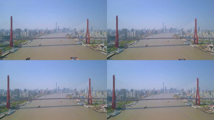 中国上海，以陆家嘴金融贸易区为背景的杨浦大桥横跨黄浦江的无人机航拍画面。