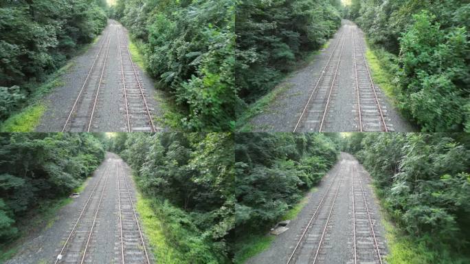 废弃铁轨航拍镜头(4k 30fps)从上方拍摄，向前飞行，向后(杂草丛生的铁轨，领带，路权)骑行