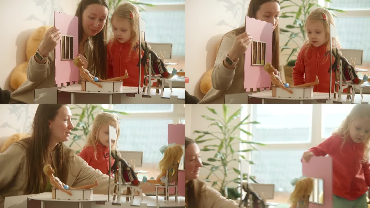 母女俩在组装过程中的木制娃娃屋，粉色时尚娃娃屋