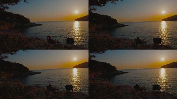 日落时分，女子在椅子上放松，看着美丽的大海