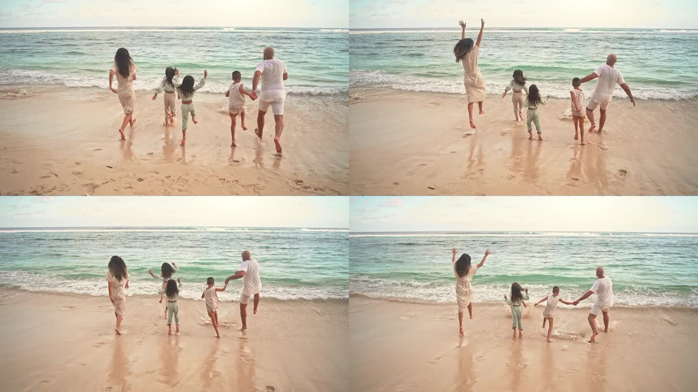 一个快乐的家庭，男人和女人带着孩子在海洋海滩的海水中奔跑。热带旅游可爱的孩子们活跃在海边与妈妈和爸爸