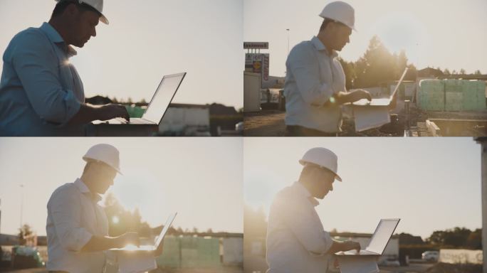 在阳光明媚的建筑工地，背光的男建筑工人使用笔记本电脑