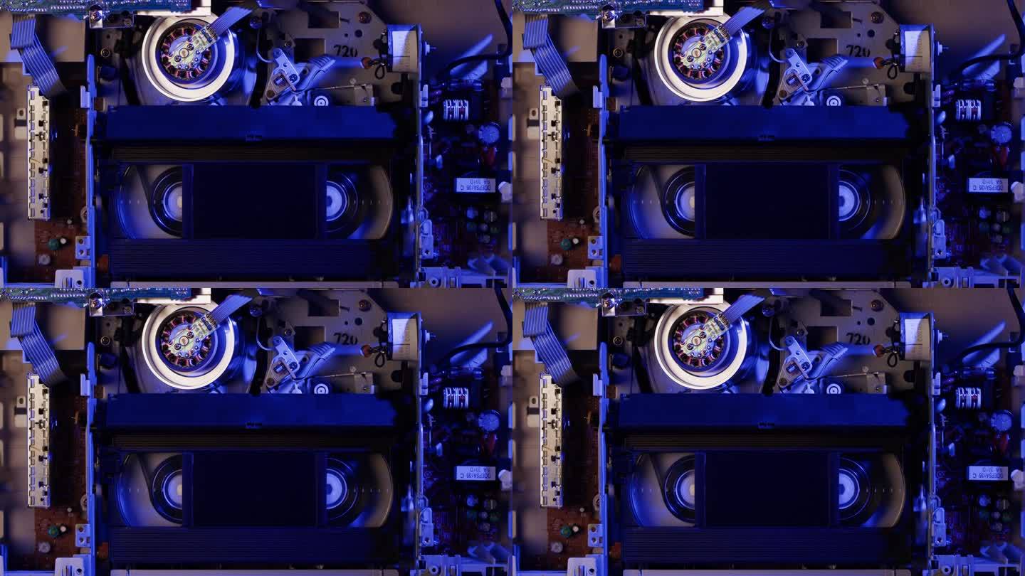 旧录像机里面的特写，VHS。复古播放器在霓虹蓝光，老式录像带广播，录音带。