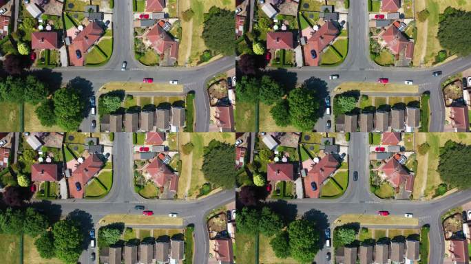 这是英国西约克郡韦克菲尔德市美丽的海姆斯沃斯小镇的航拍画面，显示了夏季的住宅区和道路交汇处