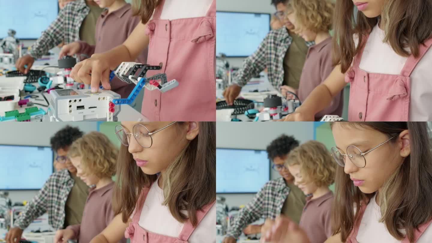 年轻的白人女孩按下电动机器人模型的按钮