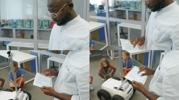 黑人男教师向幼儿展示送货机器人的设计