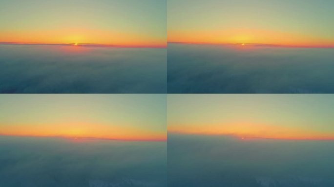 无人机在云层上飞行，日落时黄色的太阳消失在地平线上。空中无人机全景视图和天空复制空间