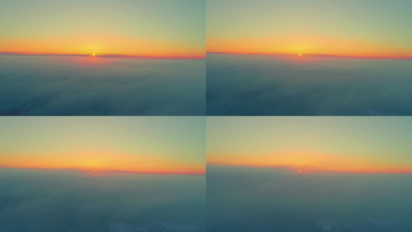 无人机在云层上飞行，日落时黄色的太阳消失在地平线上。空中无人机全景视图和天空复制空间