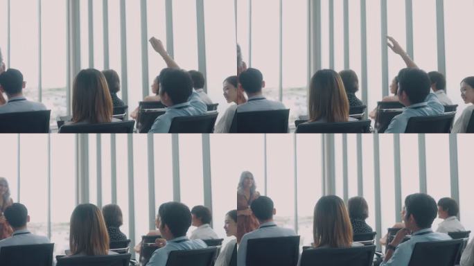 在董事会会议室的研讨会上，一名亚洲男子举手提问。