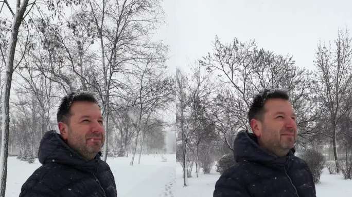 一个人在公园里享受下雪天——一个垂直视频