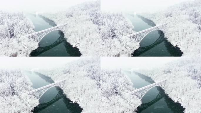 4K鸟瞰图，雪天横跨河流的山间铁路桥。
