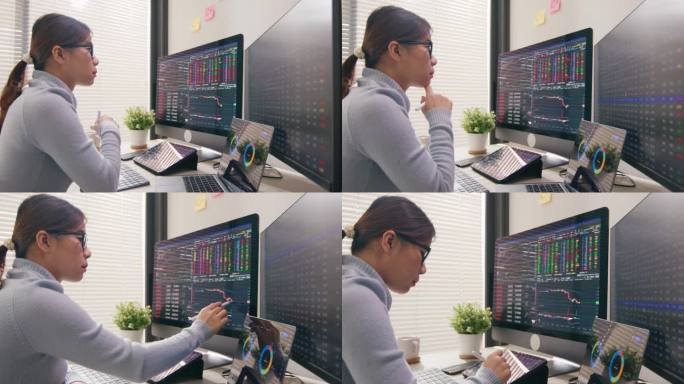 一名女交易员正在查看股票交易的显示屏