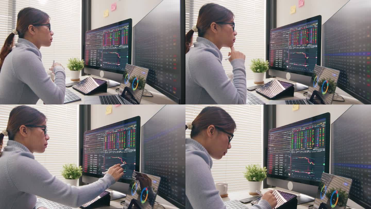 一名女交易员正在查看股票交易的显示屏