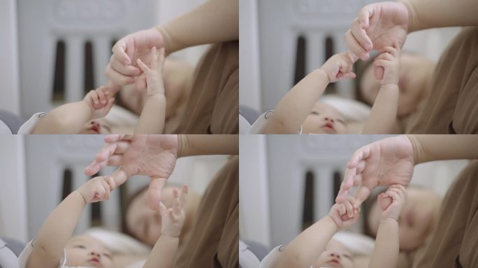 宝宝的手抚摸着妈妈的手，充满了爱的情感