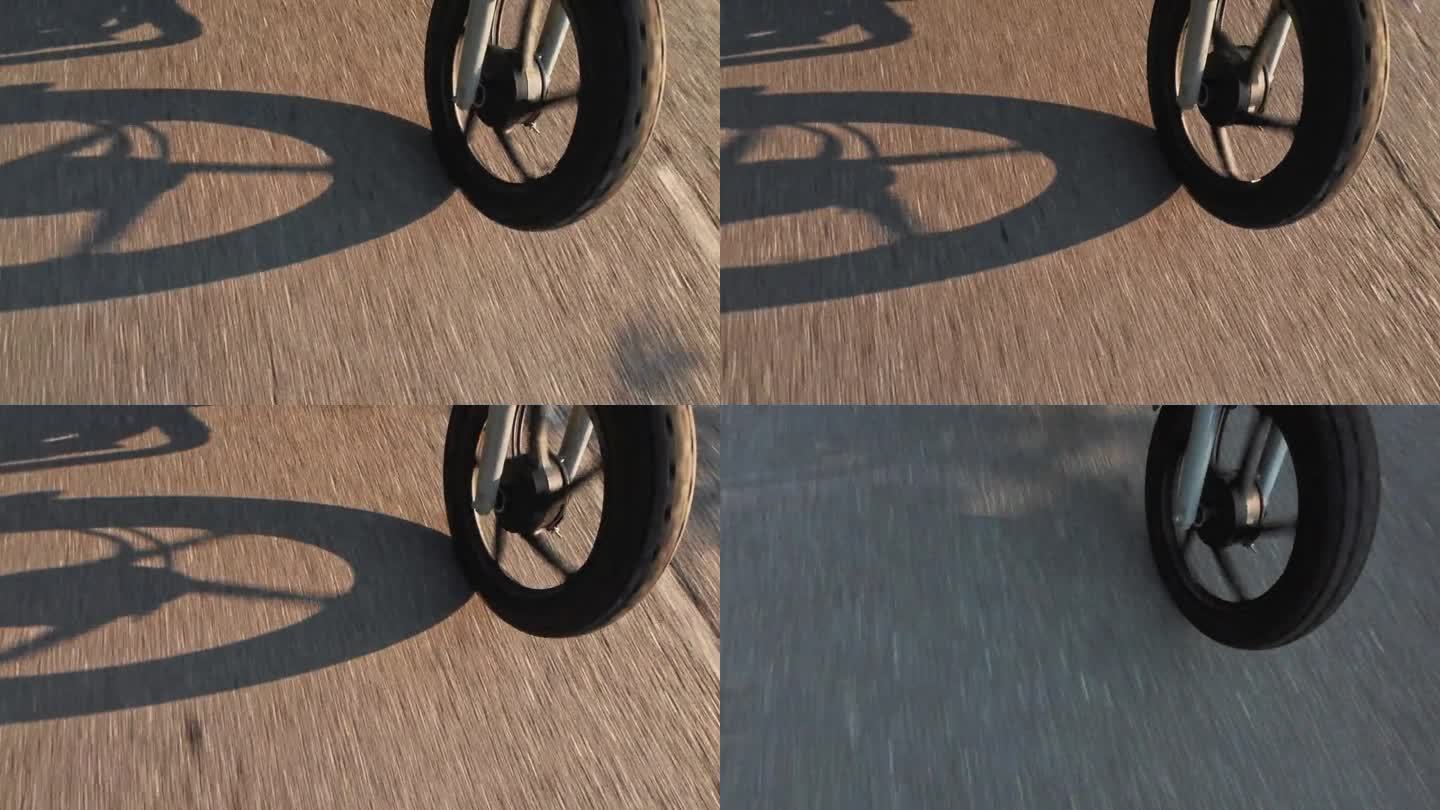摩托车车轮在日落与阴影投射在道路上的细节