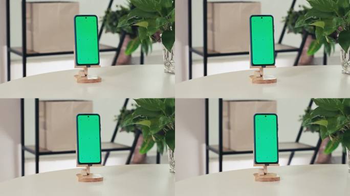 绿色色度键屏的智能手机在客厅桌子上的木制支架上
