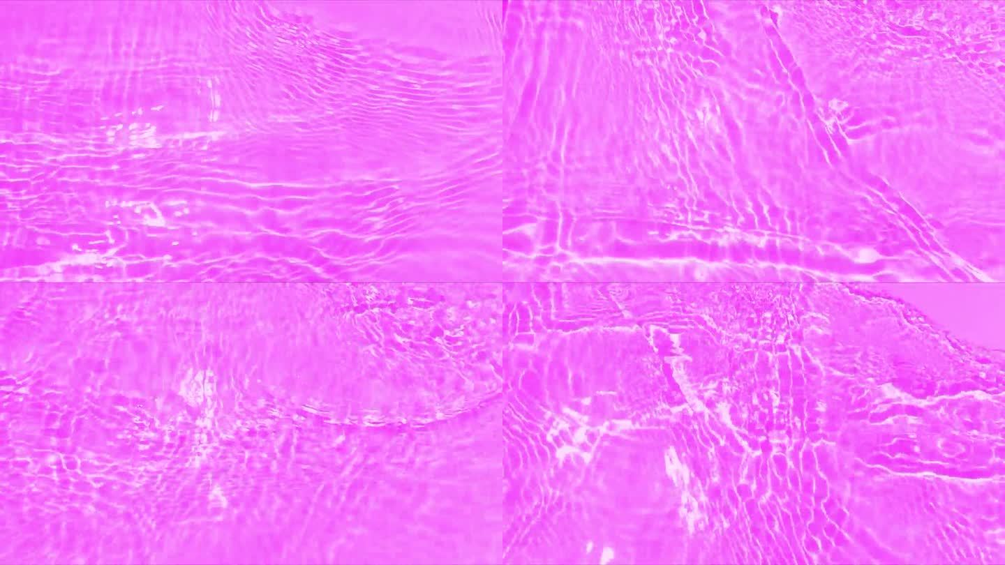 紫色的水面上泛起涟漪。散焦模糊透明粉红色透明平静水面纹理与飞溅和泡沫。水波与闪亮的图案纹理背景。