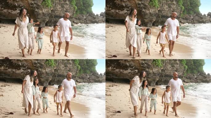 一男一女带着孩子在海滩和海水边散步的快乐家庭。热带旅游的小女孩和男孩在岸边放松与妈妈和爸爸。健康美与