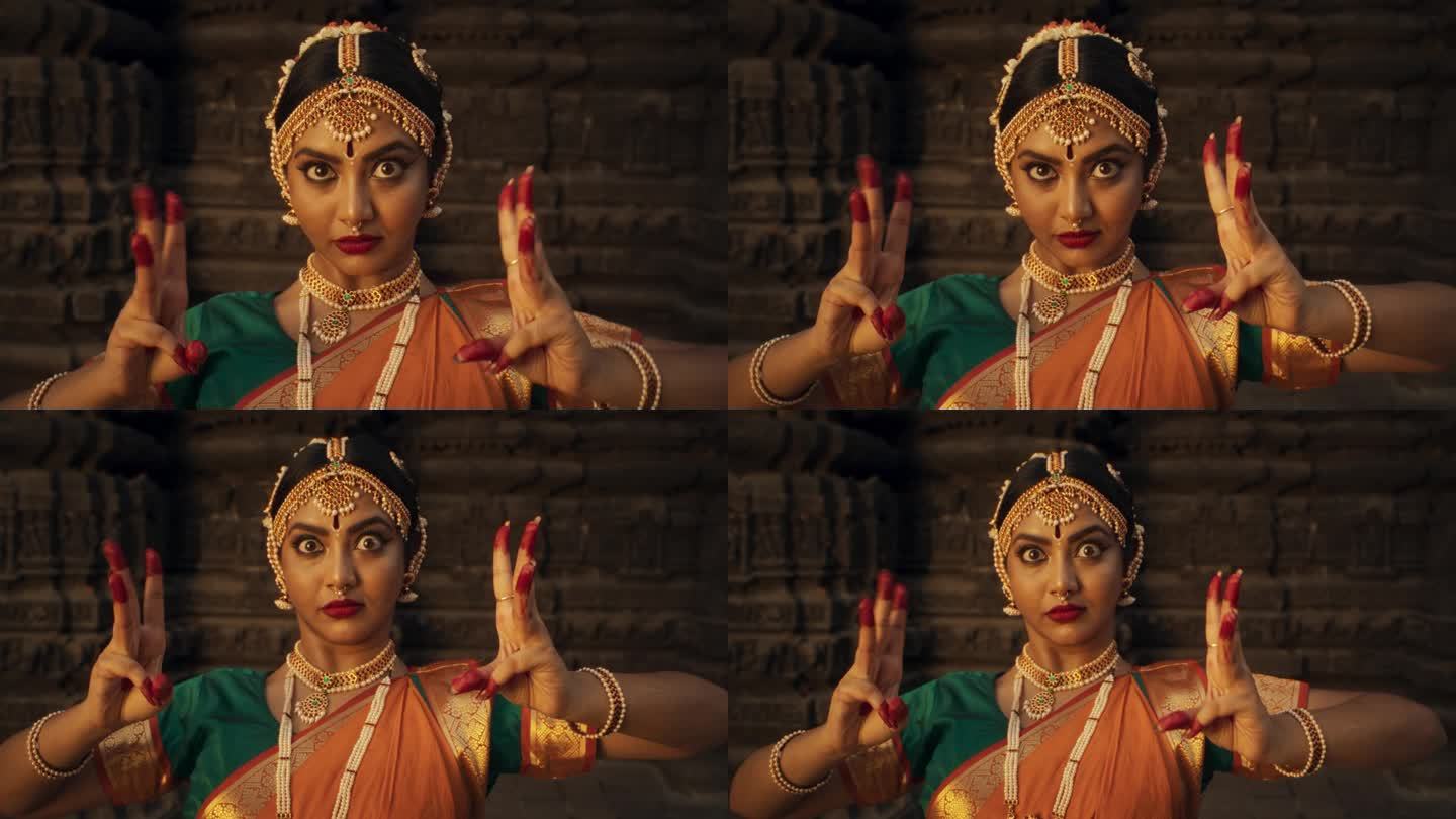 一个印度女舞者的特写，用民俗舞蹈展示象征性的手势和富有表情的脸，讲述一个故事。穿着传统纱丽的女孩展示
