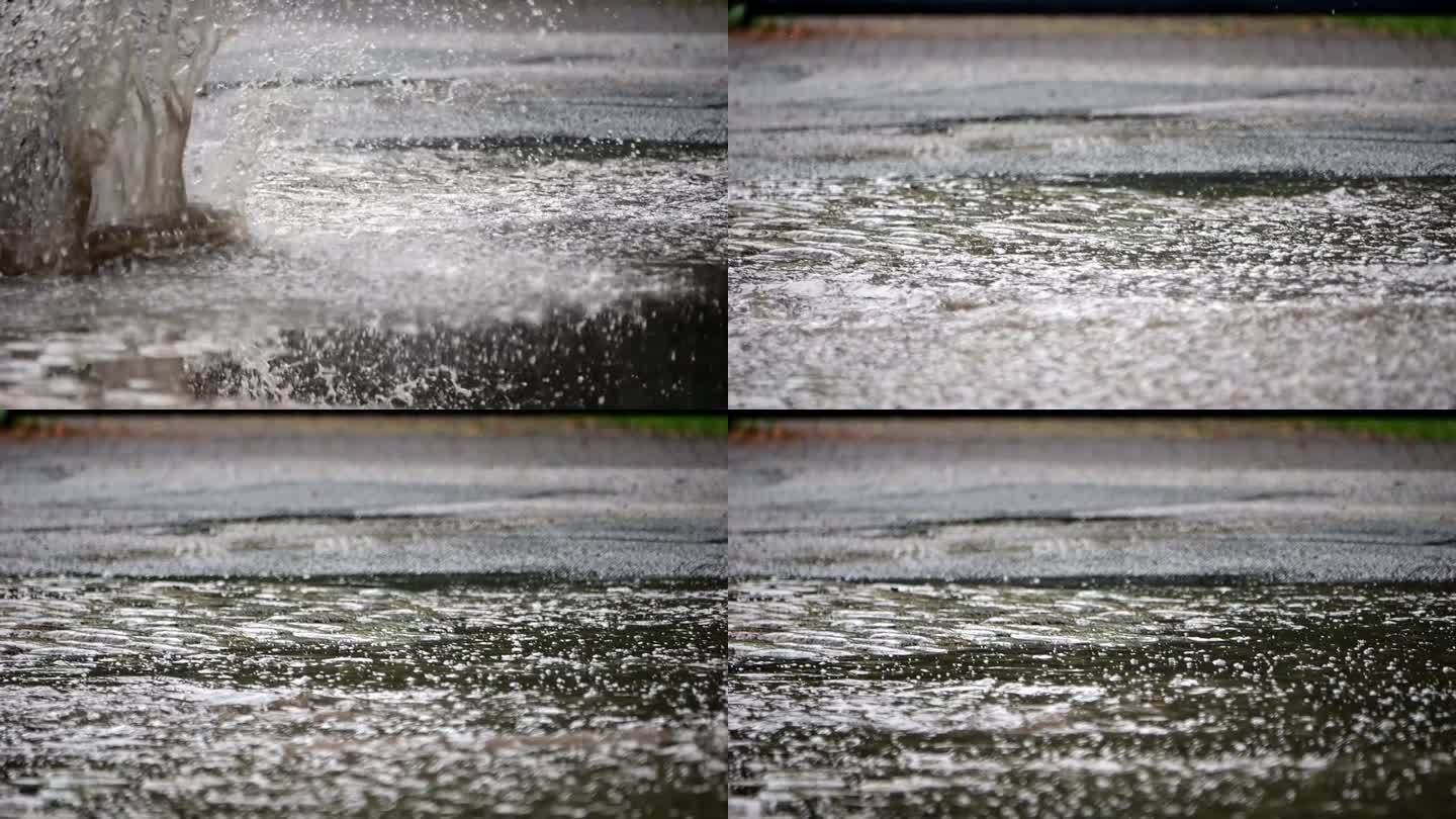 雨后汽车的车轮在水坑里溅起水花。慢动作视频。