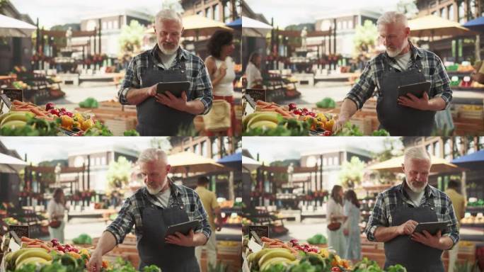 一个成年农民在市场摊位上销售新鲜有机农产品时使用平板电脑工作的肖像。中年男子在电子商务网站管理网上订