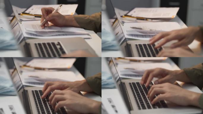 文档控制器的双手聚焦在笔记本电脑键盘上，熟练地管理、组织和处理关键文档，实现无缝工作流