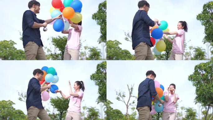 举着彩色气球的亚洲夫妇