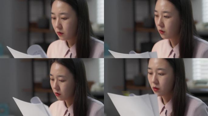 一位年轻美丽的韩国专家在她舒适时尚的办公室里坐在桌子后面的笔记本电脑上工作的肖像。亚洲女性专家处理文