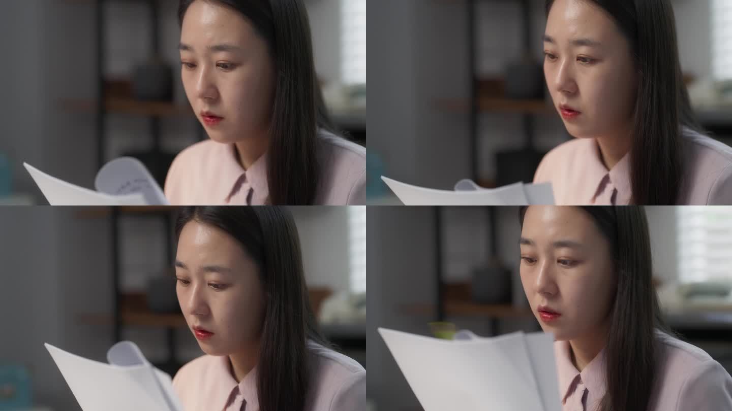 一位年轻美丽的韩国专家在她舒适时尚的办公室里坐在桌子后面的笔记本电脑上工作的肖像。亚洲女性专家处理文