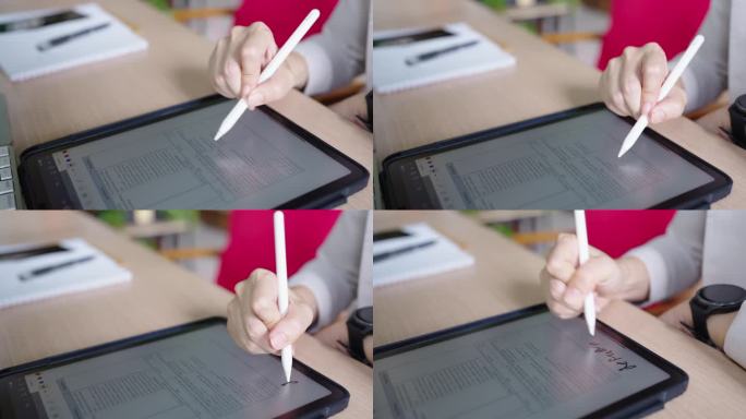 平板电脑上的电子签名，近距离手写商务女性合同协议，商务女性在办公室工作时使用触控笔在数字平板电脑上签