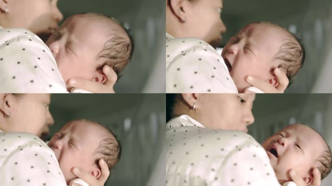 一个刚醒来的亚洲新生儿的脸部特写。大声地哭，因为他饿了。