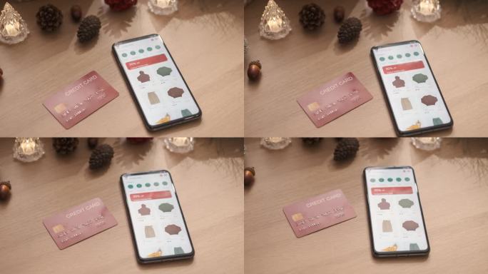 近距离移动购物应用与信用卡在圣诞装饰桌上
