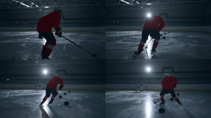 一段令人兴奋的视频片段，一名身穿红色运动衫的冰球运动员在黑暗的冰场上训练，展示了快速的动作和专业的技