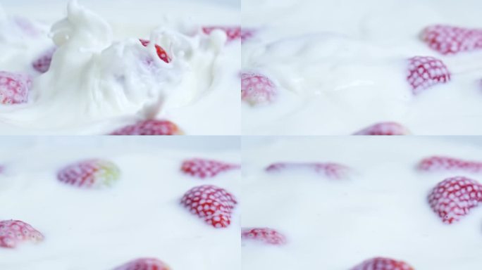 草莓落在牛奶中的微距镜头