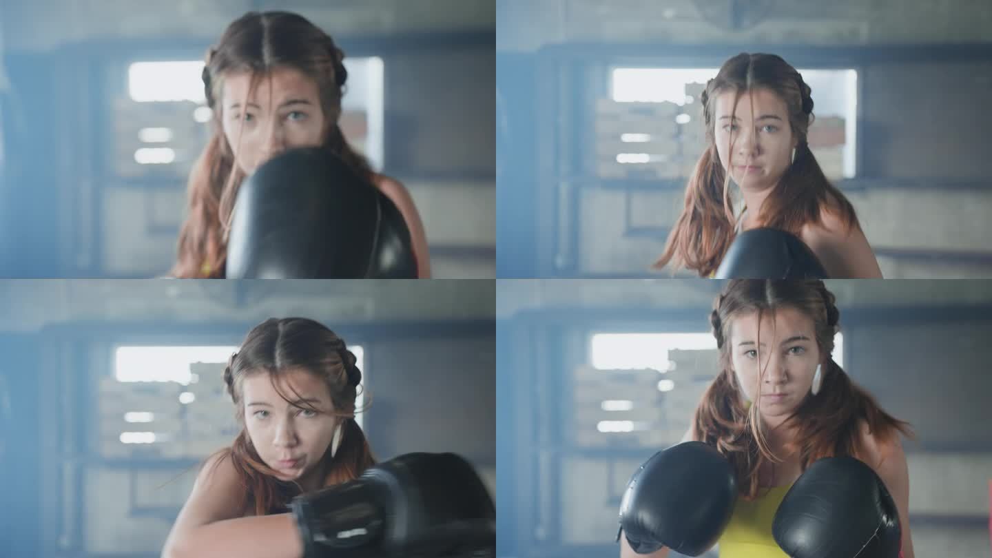 一位年轻的白人女性在拳击馆里练就拳击沙袋的肌肉。一位身着运动服、肌肉发达的亚洲女性在现代拳击馆里练就