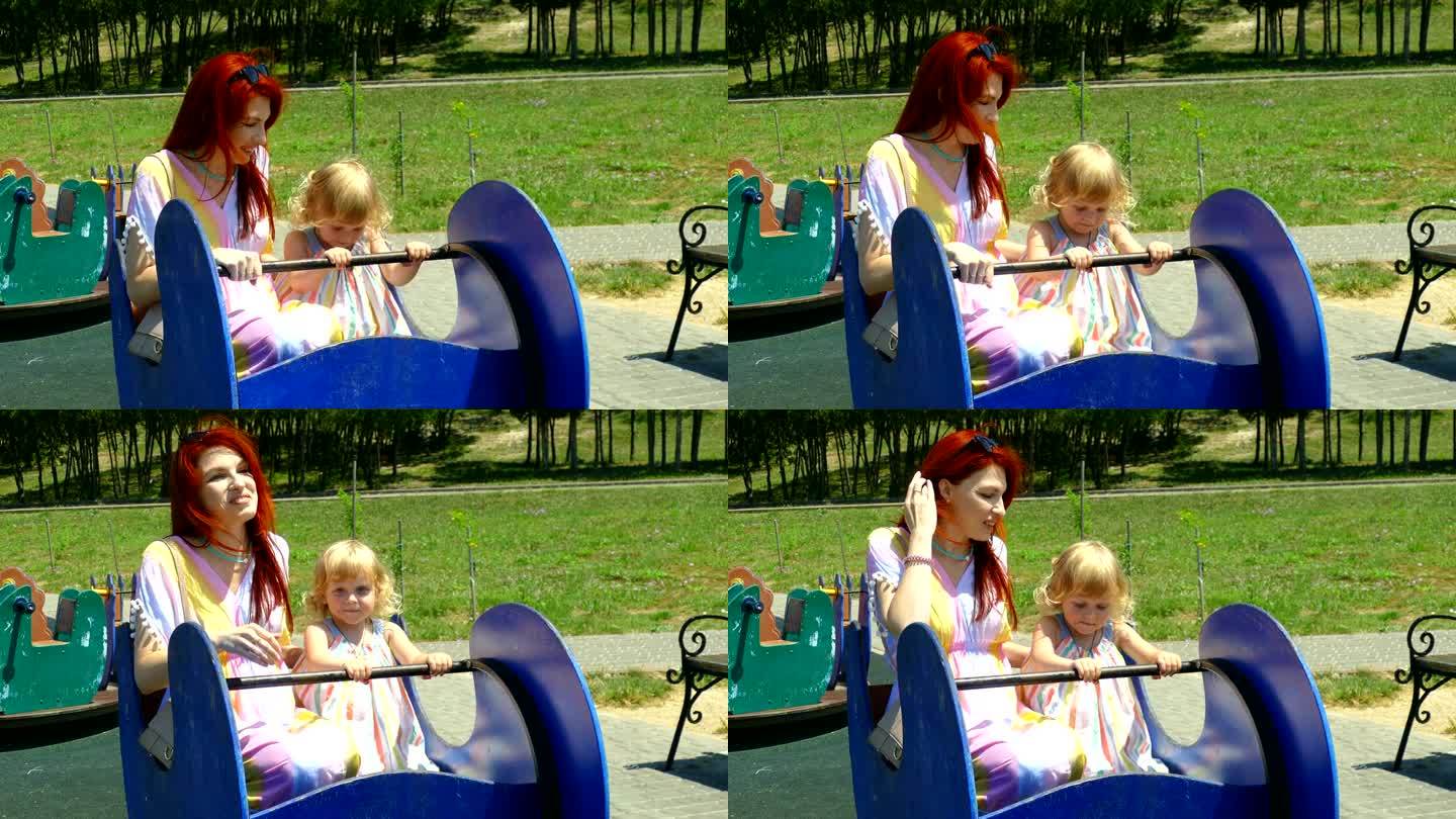 在儿童公园里，一个女人带着一个孩子在荡秋千
