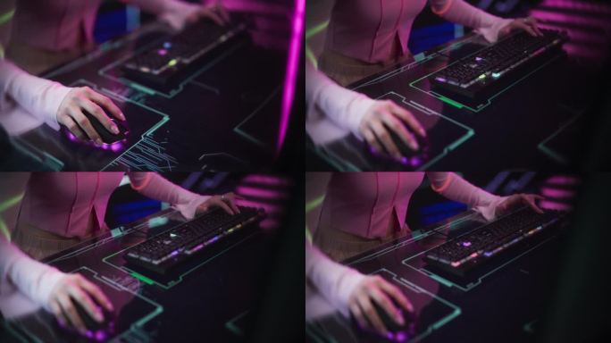 女玩家坐在彩色霓虹灯工作室的未来互动桌后。年轻女子使用键盘和鼠标在桌子上与科技动画。游戏内容的素材