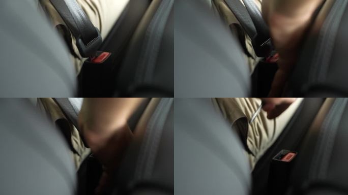 细节裁剪镜头，无法辨认的男性司机停车，解开安全带。男司机解开汽车安全带的特写镜头。