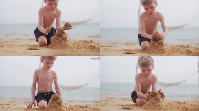 男孩在沙滩上慢慢地堆一座沙堡