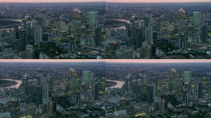 鸟瞰金丝雀码头的天际线。拥有现代摩天大楼的伦敦金融区。背景是泰晤士河。英格兰。英国。日落。用红色武器