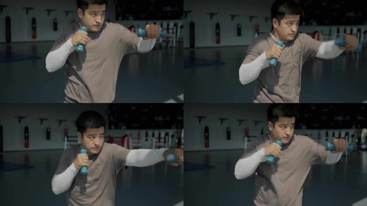 亚洲拳击手在拳击馆里用哑铃单独练习的慢动作