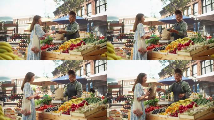 美丽的女顾客在一个阳光明媚的夏日从一个快乐的黑人女农民那里购买可持续有机蔬菜。成功的街头小贩管理一个