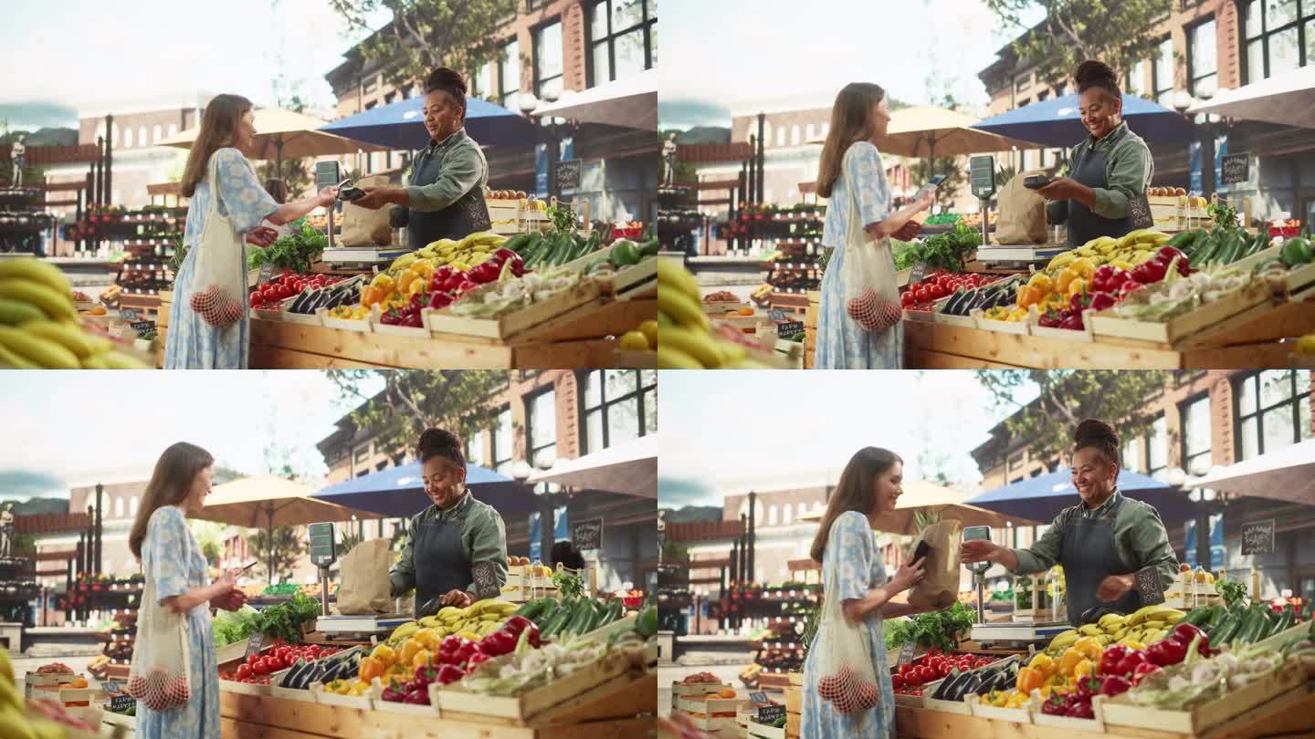 美丽的女顾客在一个阳光明媚的夏日从一个快乐的黑人女农民那里购买可持续有机蔬菜。成功的街头小贩管理一个