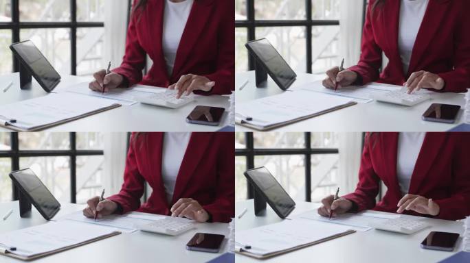 一个女人在现代办公室里用平板电脑工作的画像。制作账目分析报告。房地产投资信息财税系统概念