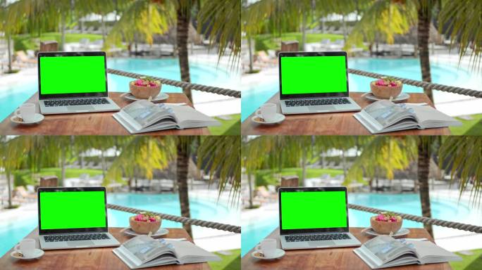 Croma键电脑特写。绿屏背景。Macbook笔记本电脑棕榈树咖啡馆