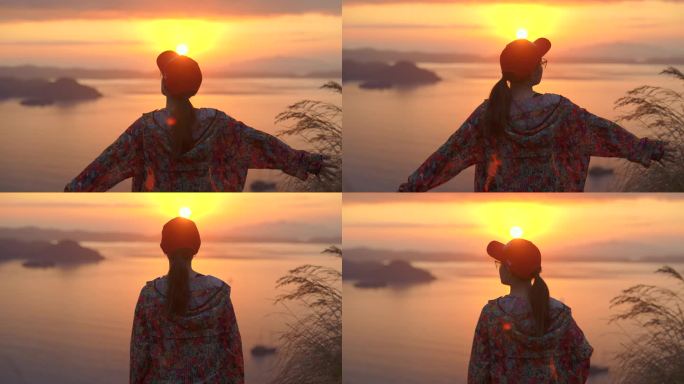 女人在山顶欣赏美丽的日落